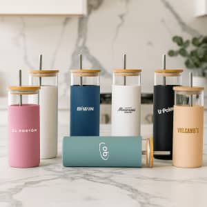A drink bottle collection featuring various styles in pastel and neutral colours, each with a bamboo lid and a straw.