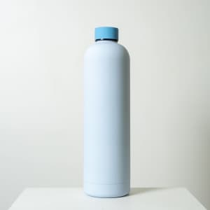 A drink bottle in a light blue colour with a blue cap. The bottle features a logo on its surface.