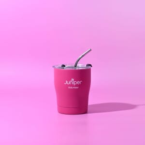 A drink bottle in vibrant pink with a clear lid and straw, featuring a logo on the front.