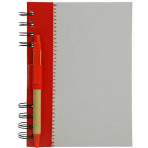 A recycled journal book with a red cover, spiral binding, and a pen attached.