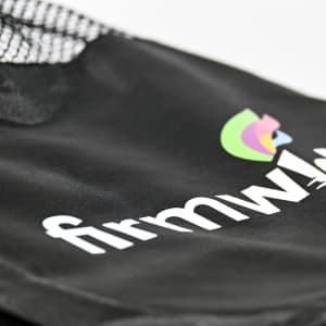 A black sports bag with a mesh overlay and logo detailing, ideal for carrying sports gear.