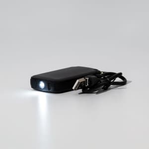 A black 2,000mAh mini power bank with a flashlight and a USB cable. It features a logo on the surface.