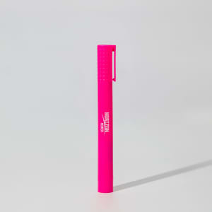 A bright pink jumbo highlighter with a textured grip and a clip, featuring a branding logo.