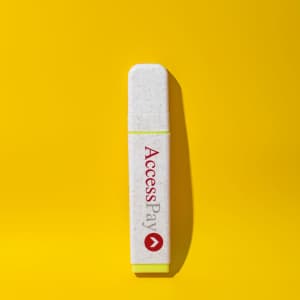 An eco-friendly highlighter in white with a yellow end, featuring a logo on a bright yellow background.