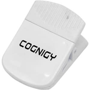 A white magnetic clip with a textured grip and a logo, designed for holding papers or other items.