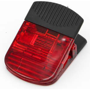 A red magnetic clip with a black top, featuring a textured surface for grip and a logo on the body.