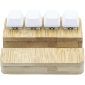 A bamboo stand holder featuring four white key pressing stress relievers on top.