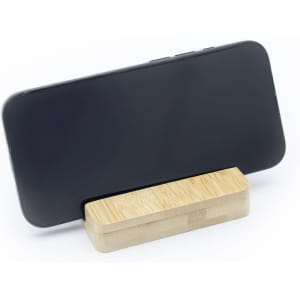 A bamboo phone stand holder with a black smartphone positioned upright on top. It features a simple, natural design.