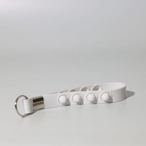 A white Popper Stress Reliever Key Chain featuring multiple push buttons and a metal keyring.