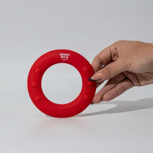 A red silicone wrist disc with a circular design and buttons, featuring a branding logo.