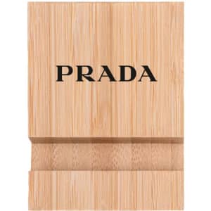 A bamboo phone holder in a natural wood finish featuring a logo on the front.