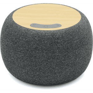 A round, grey wireless speaker with a bamboo top and control buttons, featuring a logo on the surface.