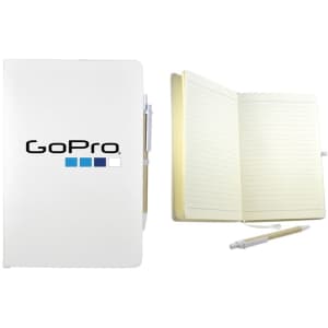 A white recycled notebook with a pen, featuring a logo, showing lined pages inside.