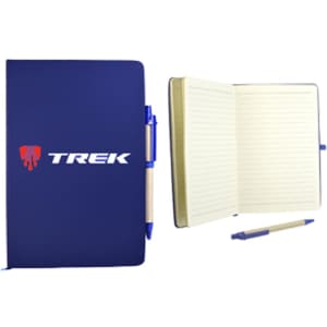A navy blue recycled notebook with lined pages, accompanied by a blue pen, features a logo on the cover.