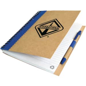A recycled paper notebook with a brown cover, blue spiral binding, and a pen, featuring a logo on the front.