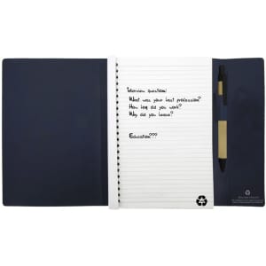 A navy Large Tuck A5 Journal Book with lined pages, a pen, and a logo.