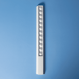 A white 30cm popper ruler featuring multiple poppers along its length, set against a blue background.