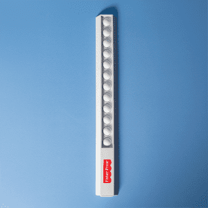 A white popper ruler featuring multiple poppers along its length and a small logo.