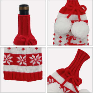 A drink bottle is covered with a custom knitted wine bottle sleeve in red and white, featuring pom-poms and snowflake patterns.