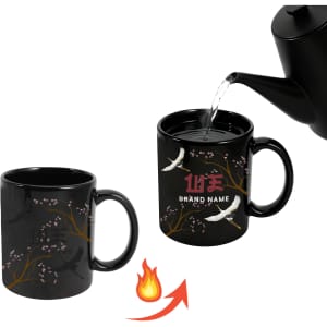 A heat-sensitive colour changing mug in black, featuring floral designs, with hot water being poured into it.