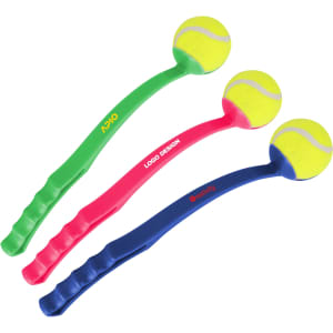 Three ball throwers in green, pink, and blue, each with a yellow tennis ball attached. The products feature various logos.