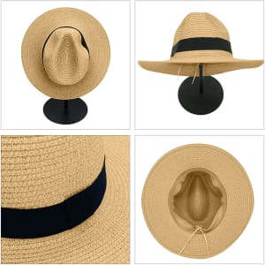 A straw hat in a light tan colour with a black band, displayed from multiple angles on a stand.