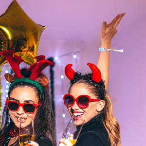 A fabric wristband with RFID card attached, featuring colourful holiday-themed accessories and party atmosphere.