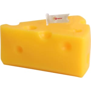 A triangular, yellow candle shaped like a cheese wedge, featuring holes and a small flag.
