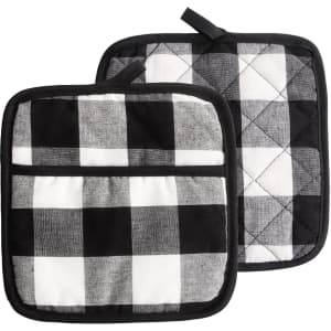 A pair of black and white quilted pot holders with a checkered pattern and a hanging loop. One features a pocket.