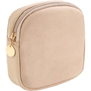 A stylish mini makeup bag in soft beige with a gold zipper and a round zipper pull. It features a simple, sleek design.