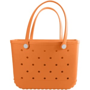 An orange EVA beach bag with perforated sides and two handles. It features a simple, modern design.
