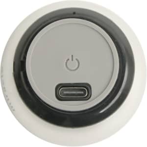 A round, white mini bass wireless speaker featuring a grey power button and a USB-C charging port on the base.