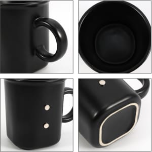 A black ceramic coffee mug with a matte finish, featuring a unique shape and a logo on the side.