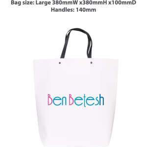 A large white boutique paper bag with black handles and a logo printed in blue and pink.