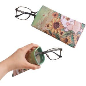 A full colour print glasses pouch with floral and animal designs in green and pastel tones, featuring a logo.