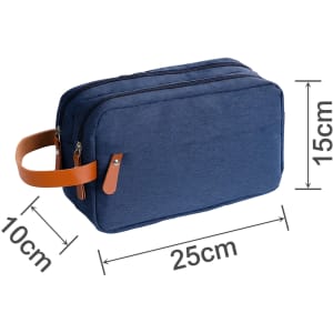A navy toiletry bag with a brown leather handle, featuring two zipper compartments and rectangular shape.