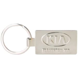 A silver die-struck keyring with a rectangular shape and a logo on one side, attached to a metal ring.