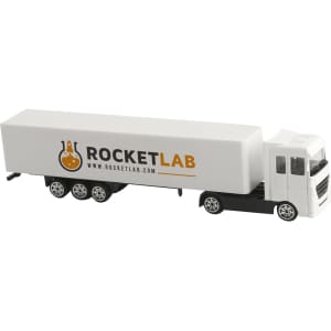 A white toy truck with a grey cab and a large, white trailer featuring a logo.