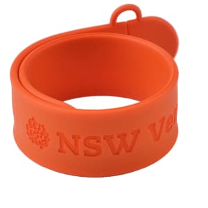 An orange silicone slap band flash drive with a looped end and an embossed logo.