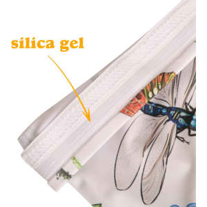 A close-up of a colourful fabric sleeve, featuring a design with insects and a silica gel tag on the edge.