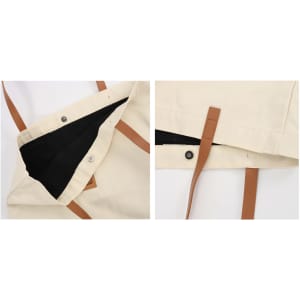 A cream canvas bag with brown leather straps, featuring a black interior and snap closures. Includes branding.