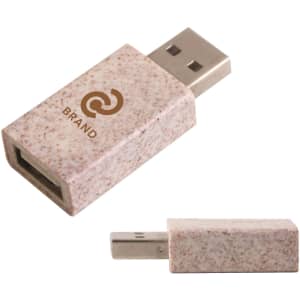 A wheat straw USB data blocker in a speckled beige colour, featuring a logo on the surface.