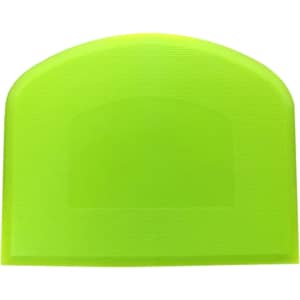 A flexible bowl scraper in bright yellow-green, featuring a textured surface and a rounded top edge, with a logo present.