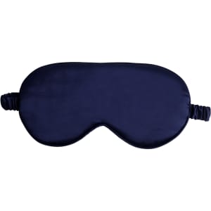 A satin sleep mask in navy blue with an elastic strap and a smooth texture. It features a logo on one side.