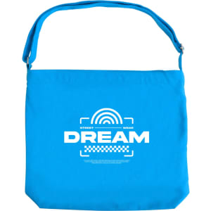 A blue canvas tote bag with a long strap and a logo featured on the front.