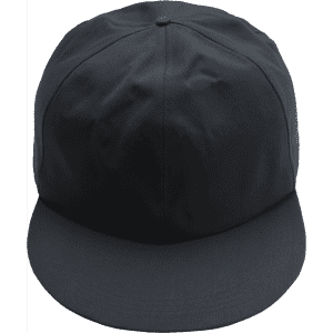 A giant black baseball cap with a flat brim and a structured crown. It features a logo on the front.