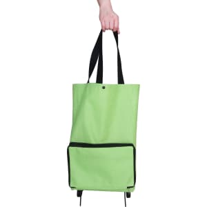 A green collapsible shopping trolley bag with black accents and a front pocket, held by a hand.