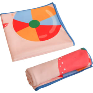 A microfibre beach towel in pastel colours, featuring a beach ball design, folded and rolled for compact storage.