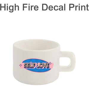 A ceramic mug in white featuring a vibrant design, including the phrase "Self Love," with a sturdy handle.