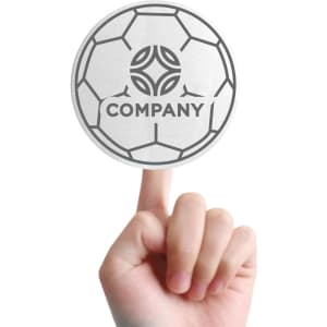 A hand holding a round promotional foam mitt designed to resemble a soccer ball, featuring a logo.